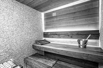 Sauna‑Ausbau Nussbaum mit Sandstein‑Mosaik